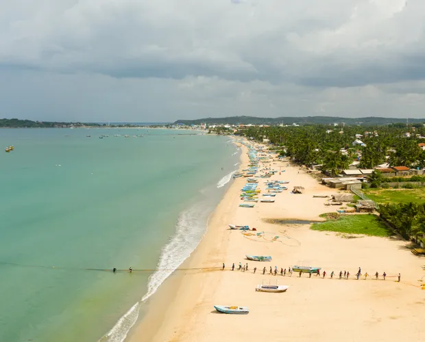 The tranquil waters and sandy shores of Bentota beach.